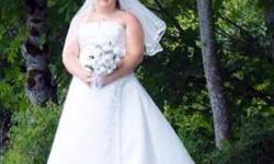 Wore my wedding dress for my outdoor wedding... It does need a drycleaning due to the underneath of the train is dirty from the ground... otherwise in great condition and a beautiful dress... it says its size 20 but it has a corset back and does go