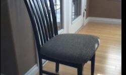 Eight dark wood dining chairs with cushioned seating. Excellent condition! Purchased from Sears.