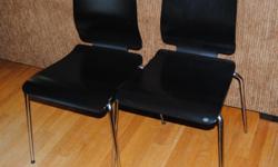 Two dining chairs in excellent condition. Wood with chrome legs.