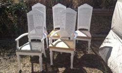 Set of five dining chairs. Painted white a few years ago but have been in storage most of the time. A few scuffs on the paint. Two captain chairs and three regular chairs. Seats are currently not attached so easy to recover with fabric to match your