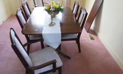 Mahogany stained and varnished dining room table in good condition, 62" long, 42" wide, 30" high, with a 16" wide insert leaf, together with 6 cherry wood chairs (two of them with arms) in pristine condition