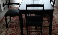 Hardwood antique dining table with 4 matching chairs
Table top glass included
Chair seats recently upholstered in faux black leather
Table dimensions: 31" W x 46" L