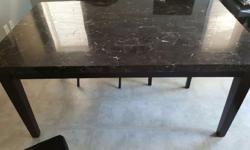 We are moving and don't have room to take our beautiful table with us so we are selling. The set is black; the table is REAL marble ( very heavy ) and comes with 4 black leather chairs. There is a chip in one of the corners which is what effects the