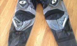 "Carbon" dirt biking pants. Black and grey. Size 30" waist with adjustable tab, can be made smaller by approx. an inch or two. Velcro hip padders. Excellent shape.