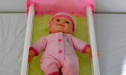 Good condition pink and while doll bed. Comes complete with baby doll to put to sleep. Small size, tucks easily under your child's bed or dresser.