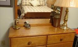 This solid maple wood dresser has six drawers and attached mirror. The matching night table has one drawer. Good condition. Cash only.