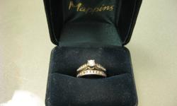 Engagement ring - white gold, round centre diamond with channel set diamonds on either side, < .90 carat, DS
Wedding ring - white gold, channel set diamonds
Both come with lifetime guarantees from Mappins/People's that includes resizing, refinishing,