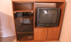 Good condition.Light brown woodgrain color with glass door, shelves, light, on wheels.4' H by 4' Wide,holds 28''wide .TV.