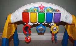 Fisher Price Piano
Piano is adjustable depending on our childs age
Baby can lay under and try to grab at the toy and watch the piano keys light up
or when walking can standup and touch the keys to make their own music