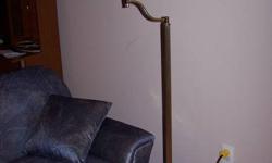 This off-set floor lamp is in excellent conditon.  It is brass with a cream shade, which could be switched out to match any decor.  It has lived in a non-smoking home and is looking to be of use to someone.
