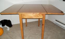 Classic solid wood table: Both sides fold down to create long thin attractive table and fold up to form a dining style table. This table is fantastic for places with limited space. Recently refinished cherry top coat. It also has slight water damage at