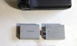 For Canon XS, XSi and T1i cameras: The genuine Canon battery grip, the 2 genuine Canon batteries that fit into it in great condition, and the original charger, everything in excellent condition (other than a bit of dust in the creases). What is displayed