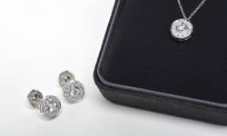 Give her the gift of diamonds this holiday season with this beautiful Tiffany's diamond earring and necklace set.
Earrings: "Tiffany's Platinum (950) Circlet Earrings" each bead and bezel set with twelve (12) round full cut diamonds totalling 0.59 carats