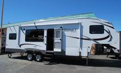 This Hornet Platinum 5th wheel features a rear kitchen layout with a large pantry, stainless steel appliances and tons of counter space. The large windows make this unit very bright and inviting. The bedroom, bathroom has a side isle floor plan, with a