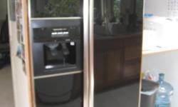 Has ice/water dispenser. Measures 69" h x 35.5"w x 30" d.
Good Condition. Black panels.