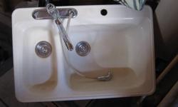 Cream/ beige kitchen sink. Good condition. Includes faucet and spray hose. Asking $150.00 or best offer.