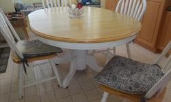 White pedestal table with blond solid hardwood top and matching chairs with portable cushions. Can be 42 inches round or add 18 inch leaf for more people. Very good condition. Offers.
