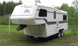 1995 24' Kodiak fifth wheel trailer, may trade on a camper - tapered front-end works well with 6.5 truckbeds - factory mass 4700 lbs - air conditioned, roof rack, dual 30lb propane, deep cycle battery, electric jacks, outside shower, three-way fridge, tub