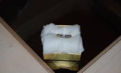 Ring currently appraised at $2330.00.
 
Appraisal report completed Aug.12/11 is as follows:
This ring is fashioned in platinum and yellow gold which is stamped Pt900 K18 and it has a total weight of 6.4 grams. It is accented by eight full cut diamonds