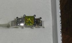 TRINITY STYLE DIAMOND RING CENTER DIAMOND IS .68 YELLOW ENHANCED DIAMOND WITH A .34 AND .35 PRINCESS CUT STONES EACH SIDE TOTAL CARAT WEIGHT IS 1.37 SET IN   A HEAVY 14 CARAT WHITE GOLD WEIGHT IS 4.6 GRAMS COLOR OF DIAMONDS IS J/K CLARITY IS I1 COMES WITH