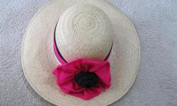 Cute straw hat in good condition. with pink & black sash tied in the shape of a flower. In very good condition. From a clean, n/s, n/p home in View Royal.