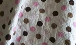 brown and pink ladybug crib bedding with quilt, bumper pads, crib sheet, and crib skirt