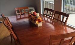 This dining room table and chair set will add elegance to any dining space. It is large enough to seat 8-10 comfortably with both leaves inserted. The set is in good condition, with some scratches and wear, most of which can be hidden with a tablecloth.