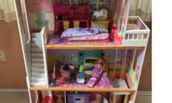 Barbie doll house with elevator and door bell. Stands over 4 feet high and comes with 2 Barbies, all the furniture in pictures and some other accessories. This is a solid house (not made of plastic)and in very good condition. Comes from a pet and smoke