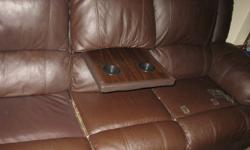 I am selling a leather couch of mine, it is a 3 seater, dark brown colour, and the middle portion can be switched into a table. The couch is less then 2 years old and is in great shape still, two of the seats recline as well. There is a few small tears in
