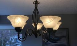 Traditional pendant light fixture with dark metal stem/arms and six white petal cups. All pieces in excellent working condition and all bulbs included. Selling due to dining room remodelling.