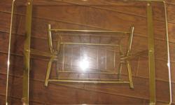 Brass magazine rack with glass top table.