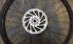26" Mavic front rim with Shimano rotor, good condition, only minor scuffs in the paint, nice & straight, through axel.