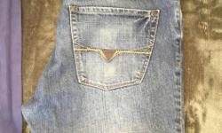 Sized 32 Men's Slim Straight Jeans in a medium wash.
