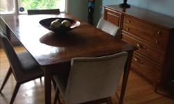 Oak mid century table and 4 chairs. Table measures 56" by 35" with the two leafs. The set is very sturdy and in good condition. The chairs will need cleaning but no tears or rips in fabric. You can easily do slip covers for the chairs and it would go