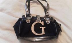 Mini GUESS Purse
 
Lightly Used - In new condition - black/silver/grey outside and giraffe like animal print on the inside
 
This Purse is perfect for going out. Will hold necessities like phone, camera, ID, ...
One zippered Pocket inside
 
paid $70.00