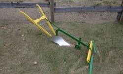This plow was made for a team of miniature horses, but was never used . Would also make a neat lawn ornament. Over all length is 5 feet, the handles are 28 inches from ground and the evener is 44 inches wide asking $250.00  Also have a garden cultivator