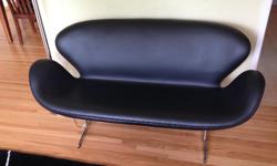 Modern black leather sofa, with aluminum legs. Very good condition. Condo size, 57" overall width.