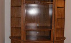 Oak wall unit, tan in colour.  Comes in three pieces,lots of storage space.  If interested call and leave message.