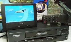 NEAR MINT & BARELY USED ~ Sylvania 6261CVB VHS VCR Video Cassette Recorder Player
with Original Remote Control... One Brand New VHS Tape... and A/V Cables
***Please note: the small TV screen in the photos is not included in the sale... it is for