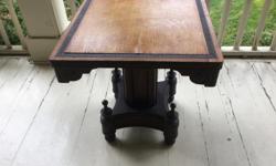 Very unusual antique games table. Oak top with leather accents/trim. Beautiful base with finials. Top 28" x 28". Good condition (top refinished) but the top needs to be screwed to the base.