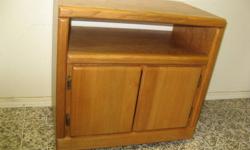 Melamine construction with oak laminated finish, solid oak doors and trim. Cabinet is on wheels. Measures 26 3/4" wide x 16 3/8" deep x 25 1/2" high. Equipment compartment is 6" high. Excellent condition.