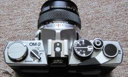 OLYMPUS OM2 SLR CAMERA, 3 LENSES INCLUDED, I- OLYMPUS 50 MM, 1- VIVITAR SERIES 1- 70-210 MM, 1- KIRON 80-200 MM. HAS RECORD DATA BACK, COMES WITH STRAP AND CASE. CAMERA HAS NOT BEEN USED FOR QUITE SOME TIME. IN GOOD CONDITION.