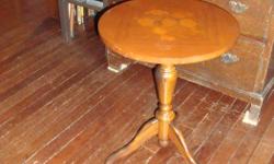 Older solid mahogany pedestal table, with inlaid work. Sturdy and in very good condition. Size: 16" diameter by 21" high.