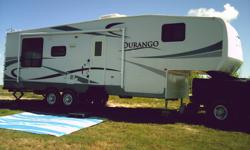 PRICE REDUCED TO $25,900.  Words cannot describe the beauty in this  30.5' 5th wheel Durango,  Sit back in the rocking chairs in front of the fireplace and watch a movie or enjoy your favorite music.  Has a DVD home theatre system and T.V.  Has a large