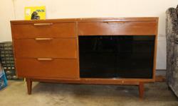 Wood cabinet, black glass sliding doors, one shelf within. Four drawers. 54"W x 16"D x 31 1/4"H.