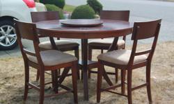60" round dining table with 4 chairs. Solid wood and included a center piece lazy susan.