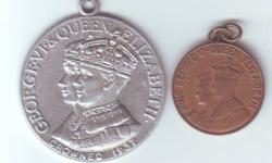 The large one commemorates the crowning of George VI and Elizabeth I in 1937, it is larger than a toonie. The smaller one is the size of a penny and commemorates their visit to Canada in 1939, both in excellent condition, $15 for the pair.
