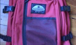 Red backpack in excellent condition. Has two large zippered compartments, one smaller zippered compartment with key holder, and fourth zippered compartment with mesh pocket. Comfortable padded straps, adjustable band for hip support and cinch straps both