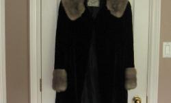 Ladies medium Sealskin coat with Mink trim. This was made by Scuby Furs in Victoria in the 1960's It is in excellent condition.