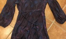 This is a gorgeous comfortable 100% silk dress I bought in an art gallery a few years ago. Made by "Full Circle". Size small but fits more like a medium. Really beautiful piece that you can dress up or down. paid an arm and a leg new and wore it maybe a